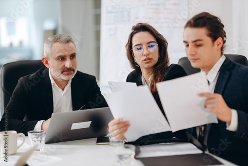 Wallpaper Mural Businessmen check documents before signing a contract. A team of businessmen is preparing to sign a contract during a meeting. Torontodigital.ca