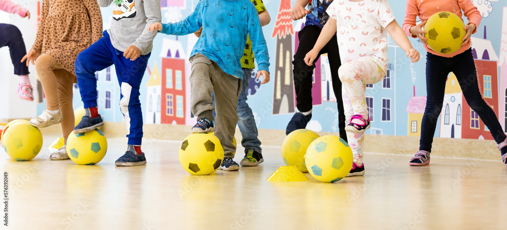  Foto zu Children in kindergarten at soccer class. Group of kids with foam 