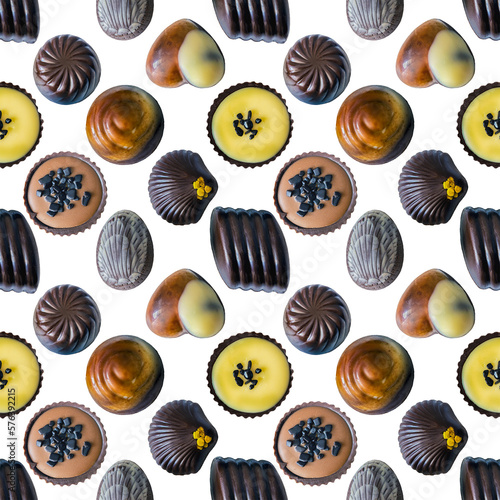 A set of dark, white and milk chocolate candies on a white background as a pattern