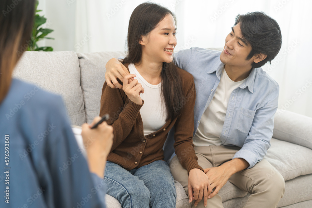 Psychology, depression asian young couple love, patient consulting problem mental health with psychologist, psychiatrist at clinic together, husband embracing shoulder of wife, therapy health care. Psychology, depression asian young couple love, patient consulting problem mental health with psychologist, psychiatrist at clinic together, husband embracing shoulder of wife, therapy health care.