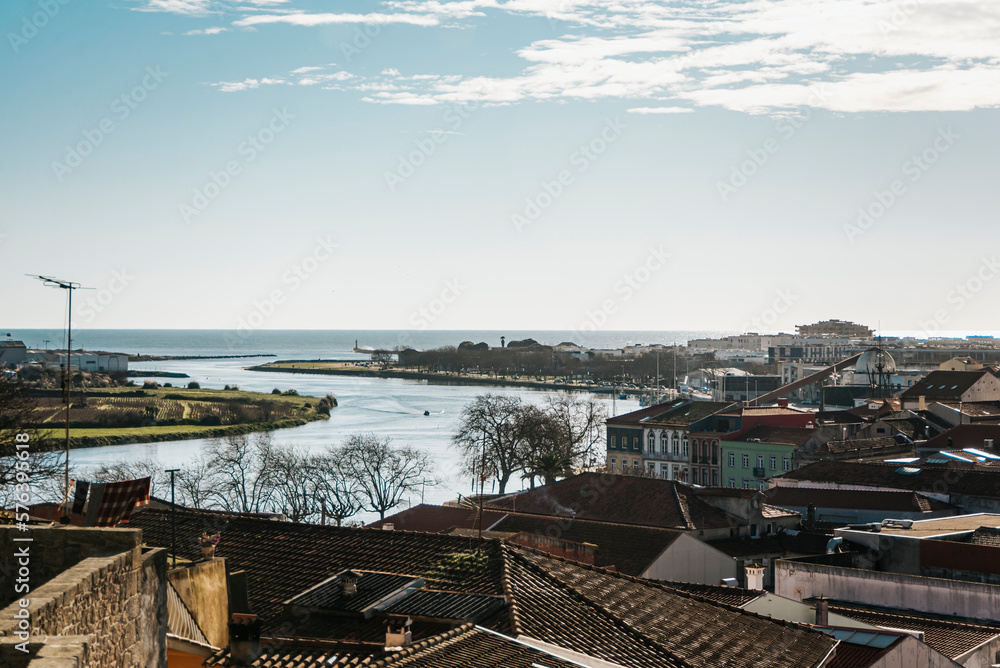 Symmetrical view between sky and roofs of old houses in the city; Ave river, Vila do Conde Porto, Portugal Symmetrical view between sky and roofs of old houses in the city; Ave river, Vila do Conde Porto, Portugal