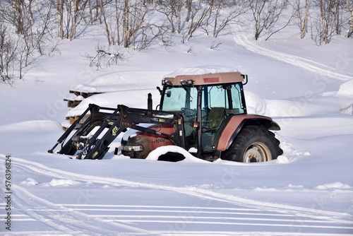 Hovden, Norway, February 21, 2023. Tractor half buried in the snow. 