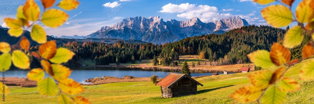 panoramic view to rural landscape with mountain range and lake at autumn