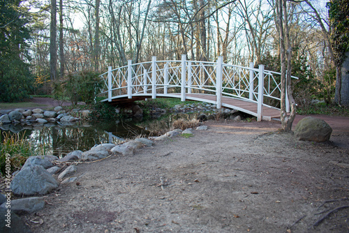 Scenic view of a small bridge crossing over a pond in Sayen Gardens, Hamilton, New Jersey, USA, on a bright, winter day -07