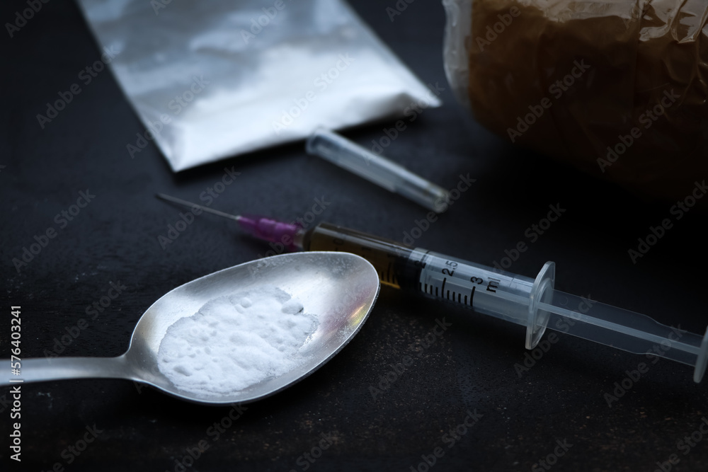 Heroin liquid and heroin powder on a black background Heroin liquid and heroin powder on a black background