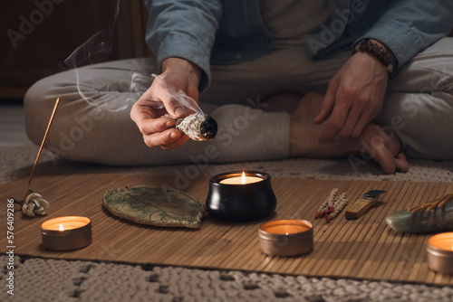 Man lighting incense for meditation and spiritual practice