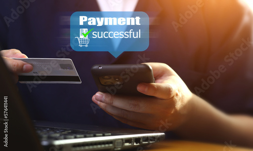 Male hand holding credit card and smartphone with a payment successful by using online banking for payment for services or goods from shopping, ordering in internet shop.
