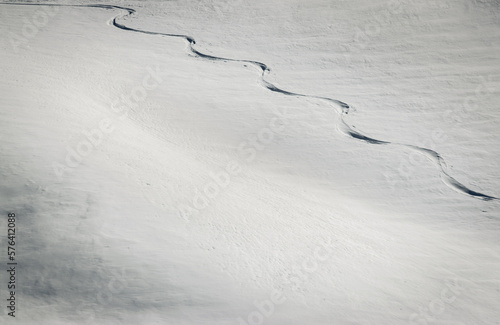 Fotografie Lone trail of backcountry skier in deep snow