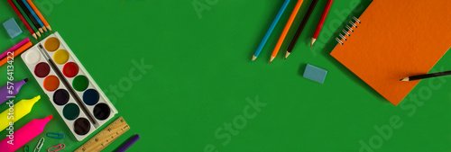 School stationery on the green background. Top view. Copy space.