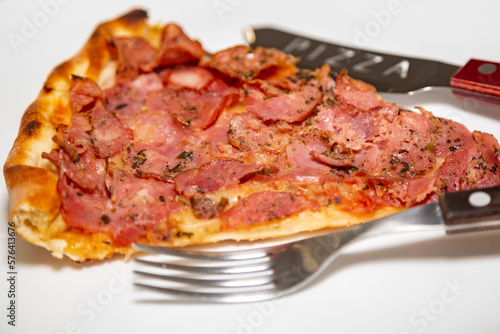 Traditional pepperoni pizza slice in selective focus.