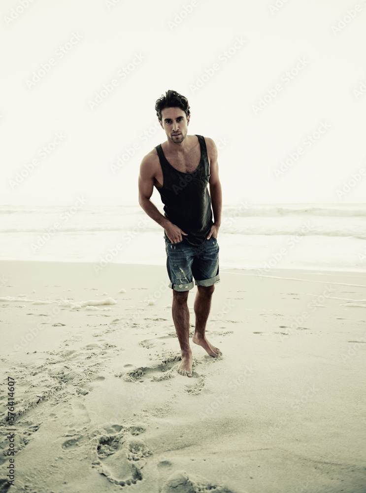 Theres no better place to relax. Cropped shot of a handsome young man on the beach. Theres no better place to relax. Cropped shot of a handsome young man on the beach.