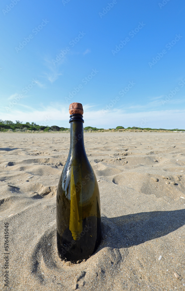 Bottle of green green abandoned on the beach Bottle of green green abandoned on the beach