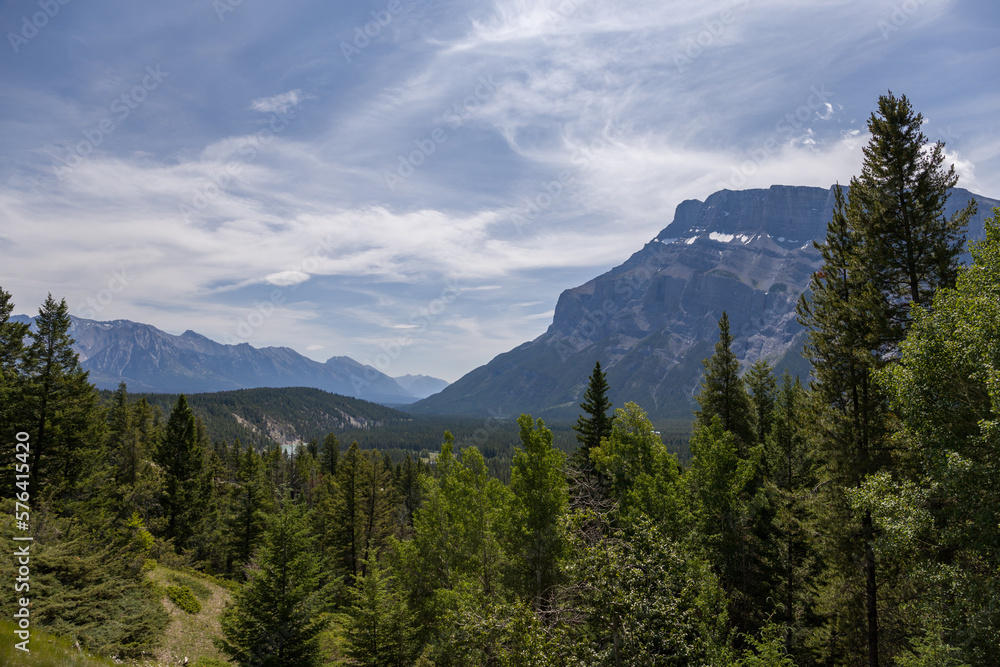 Fototapeta premium Natural landscape - Bow River Valley, Rocky Mountains, coniferous forest and beautiful sky with clouds. Summer tourism in the mountains