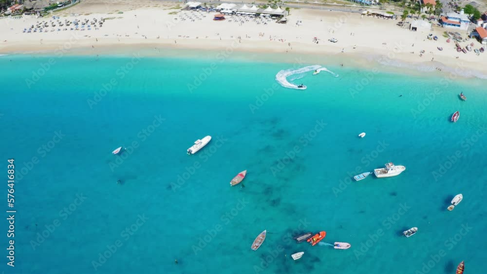 Jet Skis, boats and pier in Santa Maria, Sal Island, Cape Verde (Cabo Verde). Drone footage. Jet Skis, boats and pier in Santa Maria, Sal Island, Cape Verde (Cabo Verde). Drone footage.