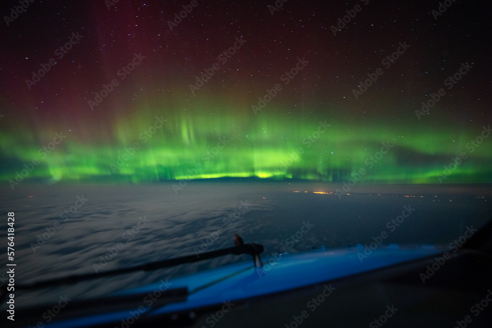 Intense beautiful Northern Lights, Aurora Borealis seen from cockpit