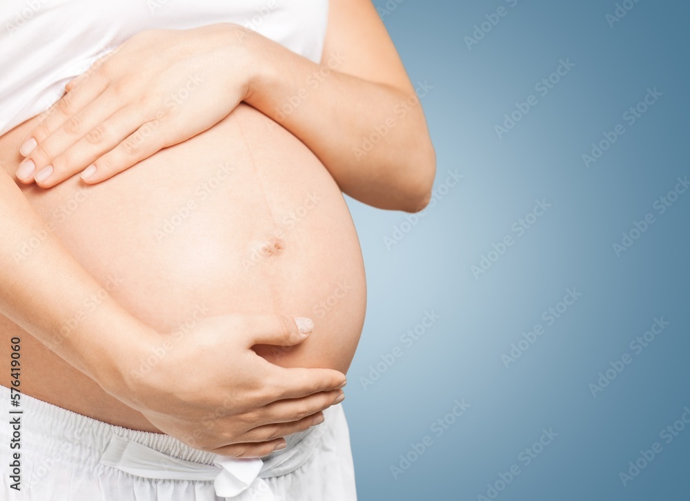 Slender young woman shows pregnant in belly Slender young woman shows pregnant in belly