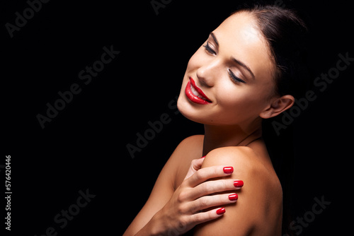 Ravenous red. A young woman with red lips and nails.