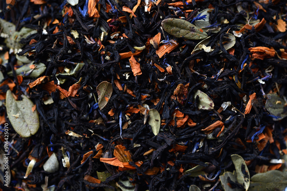 Black tea close-up. Dry tea with spices for brewing.