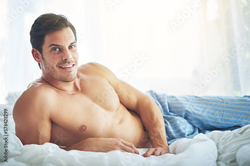 This is my weekend look. Portrait of a handsome man relaxing in bed in the morning.