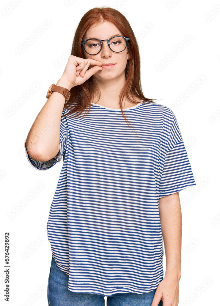 Young read head woman wearing casual clothes and glasses mouth and lips shut as zip with fingers. secret and silent, taboo talking Young read head woman wearing casual clothes and glasses mouth and lips shut as zip with fingers. secret and silent, taboo talking