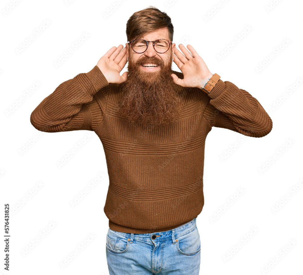 Fototapeta premium Young irish redhead man wearing casual clothes and glasses trying to hear both hands on ear gesture, curious for gossip. hearing problem, deaf