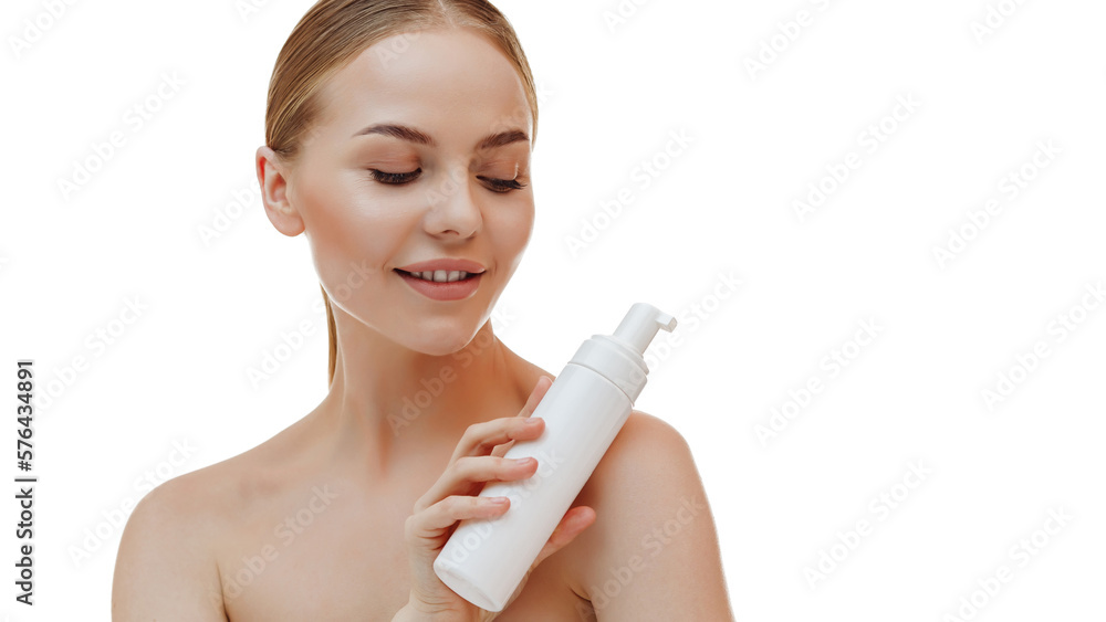 A beautiful girl with perfect skin is holding a jar of facial foam in her hands. A beautiful girl with perfect skin is holding a jar of facial foam in her hands.