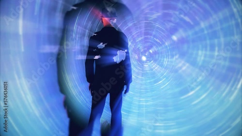 Back view of man standing in front of glowing futuristic tunnel