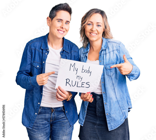 Tela Couple of women holding my body my rules banner smiling happy pointing with hand