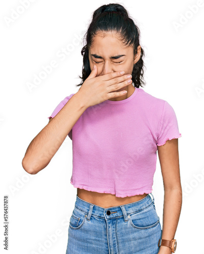 Hispanic teenager girl with dental braces wearing casual clothes feeling unwell and coughing as symptom for cold or bronchitis. health care concept.