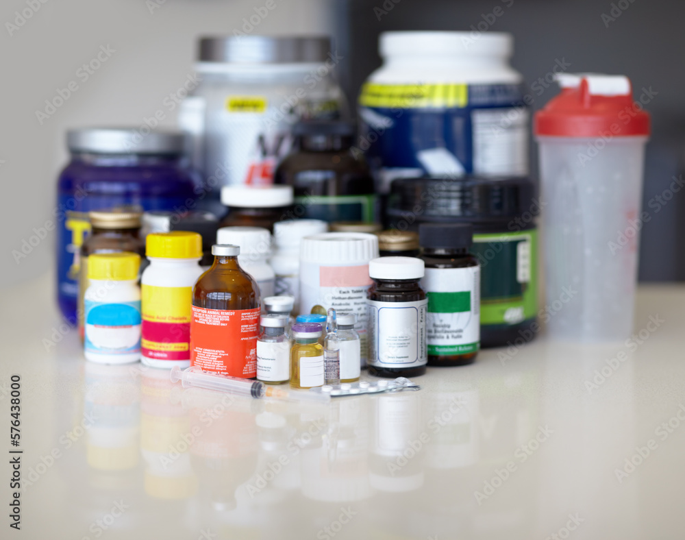 Feeding the addiction. Medicine bottles and pills with protein shakes and meal replacements. Feeding the addiction. Medicine bottles and pills with protein shakes and meal replacements.