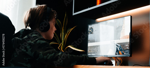 Fotografie Excited Gamer Playing and Winning in First-Person Shooter Online Video Game on His Personal Computer