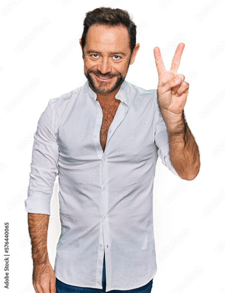 Middle age man wearing casual clothes showing and pointing up with fingers number two while smiling confident and happy. Middle age man wearing casual clothes showing and pointing up with fingers number two while smiling confident and happy.