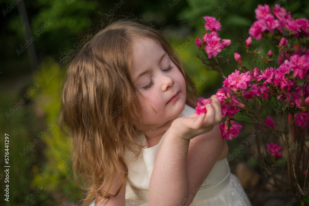 portrait of a cute girl with a pink flower portrait of a cute girl with a pink flower