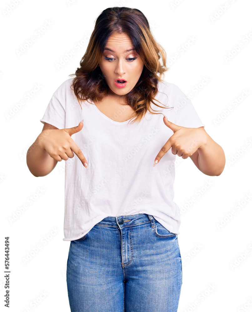 Obraz premium Young beautiful caucasian woman wearing casual white tshirt pointing down with fingers showing advertisement, surprised face and open mouth