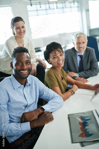 Its been a great day at the office. Portrait of a group of coworkers sitting together in an office.