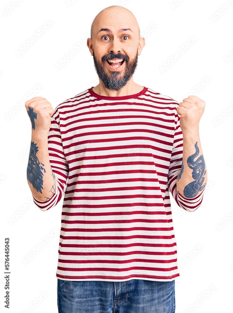 Naklejka premium Young handsome man wearing casual clothes celebrating surprised and amazed for success with arms raised and open eyes. winner concept.