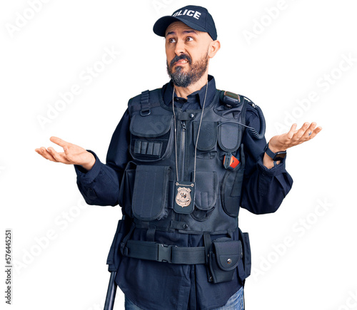 Young handsome man wearing police uniform clueless and confused with open arms, no idea concept.