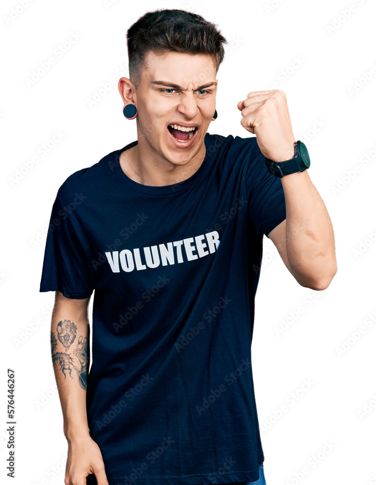 Young caucasian boy with ears dilation wearing volunteer t shirt angry and mad raising fist frustrated and furious while shouting with anger. rage and aggressive concept. Young caucasian boy with ears dilation wearing volunteer t shirt angry and mad raising fist frustrated and furious while shouting with anger. rage and aggressive concept.