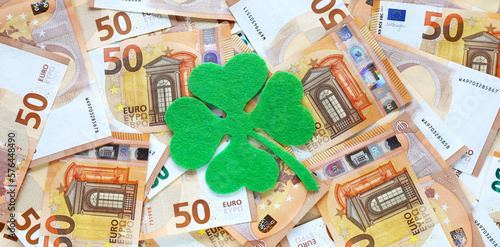 Obraz na płótnie Banner with green felt four leaf clover on 50 fifty euro banknotes background. Euro currency in Europe. Financial, bank, business. Lucky talisman. Saint Patrick's day. Place for text. w salonie