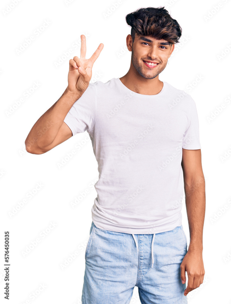 Young hispanic man wearing casual clothes showing and pointing up with fingers number two while smiling confident and happy. Young hispanic man wearing casual clothes showing and pointing up with fingers number two while smiling confident and happy.
