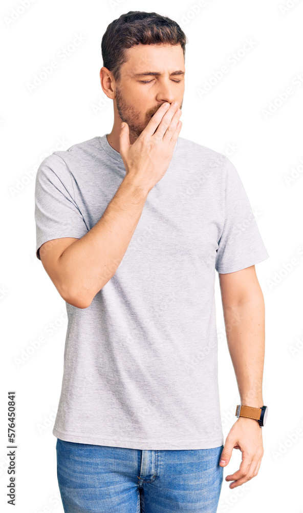 Handsome young man with bear wearing casual tshirt bored yawning tired covering mouth with hand. restless and sleepiness. Handsome young man with bear wearing casual tshirt bored yawning tired covering mouth with hand. restless and sleepiness.