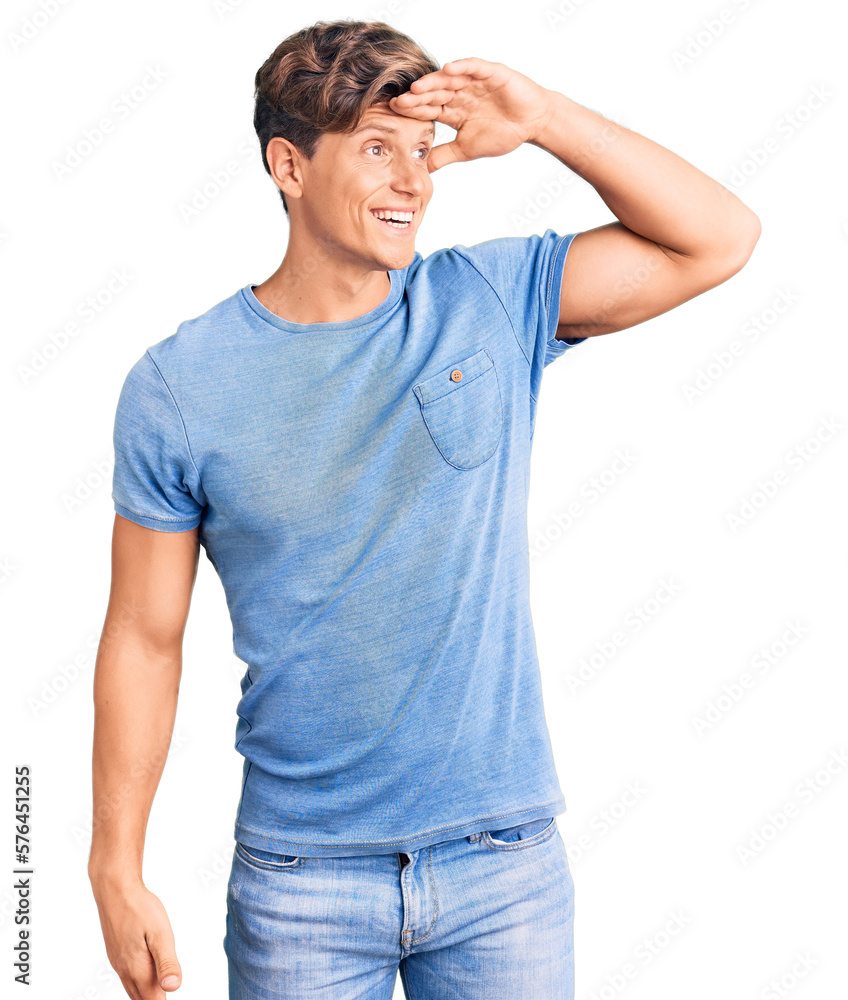 Young handsome man wearing casual clothes very happy and smiling looking far away with hand over head. searching concept. Young handsome man wearing casual clothes very happy and smiling looking far away with hand over head. searching concept.