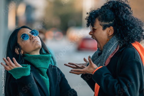 friends or girls in the street arguing angry