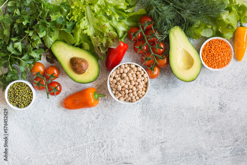 Important components of a healthy and wholesome diet: avocados, tomatoes, peppers, lettuce and grains