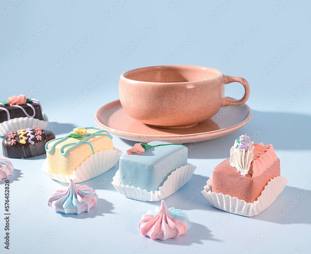 An Enchanting Espresso and Sweet Treat Experience: A Pink Mug and a Selection of Decorative and Delicious Desserts on a Pastel Blue Background An Enchanting Espresso and Sweet Treat Experience: A Pink Mug and a Selection of Decorative and Delicious Desserts on a Pastel Blue Background