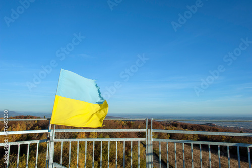 The flag of Ukraine on the observation tower high in the mountains above the Poloniny photo