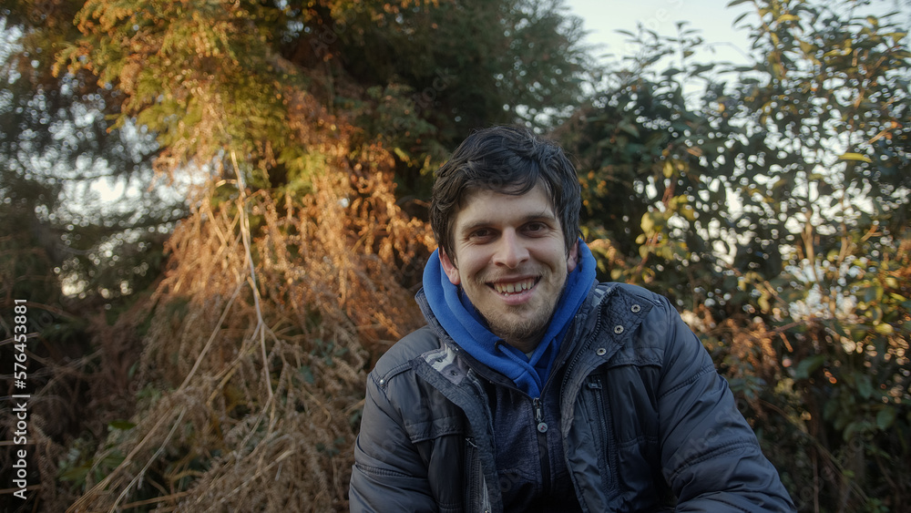 Portrait of Handsome Man Smiling at Camera in Forested Area Portrait of Handsome Man Smiling at Camera in Forested Area