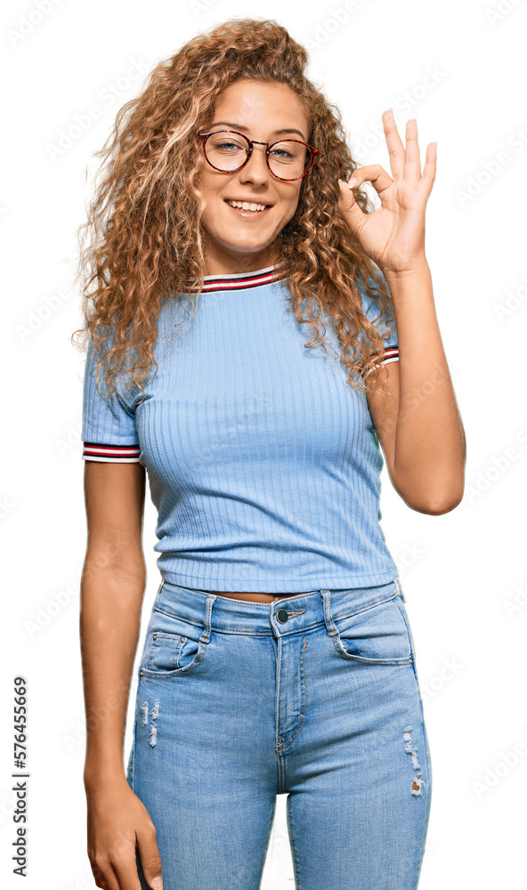Beautiful caucasian teenager girl wearing casual clothes and glasses smiling positive doing ok sign with hand and fingers. successful expression. Beautiful caucasian teenager girl wearing casual clothes and glasses smiling positive doing ok sign with hand and fingers. successful expression.