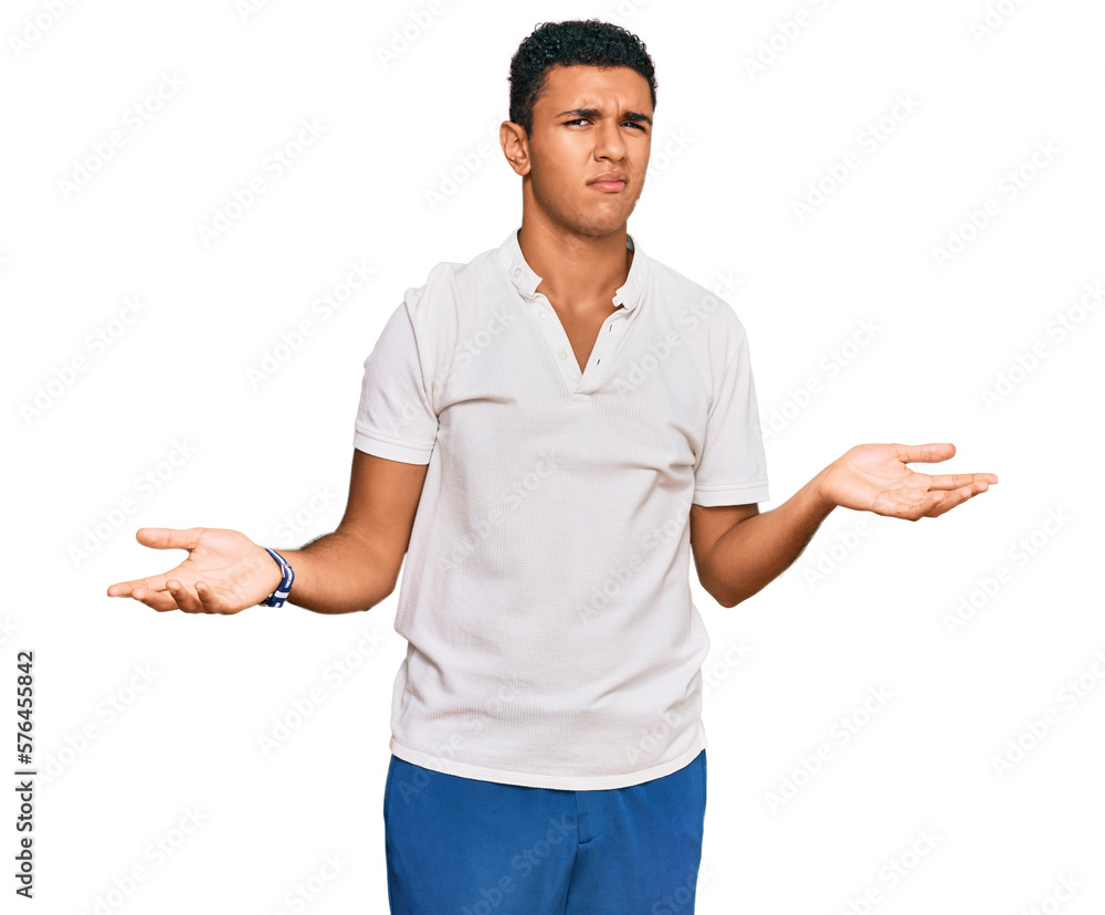 Young arab man wearing casual clothes clueless and confused with open arms, no idea concept. Young arab man wearing casual clothes clueless and confused with open arms, no idea concept.