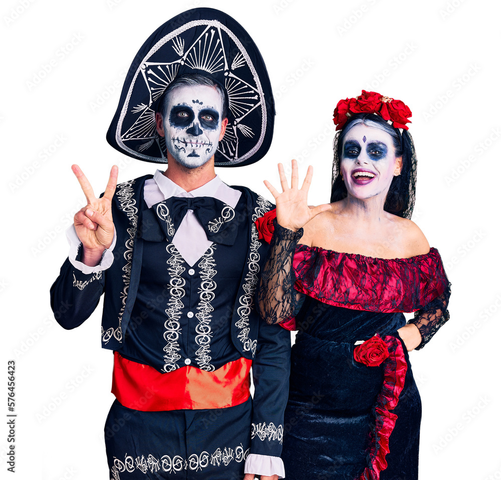 Young couple wearing mexican day of the dead costume over background showing and pointing up with fingers number seven while smiling confident and happy. Young couple wearing mexican day of the dead costume over background showing and pointing up with fingers number seven while smiling confident and happy.
